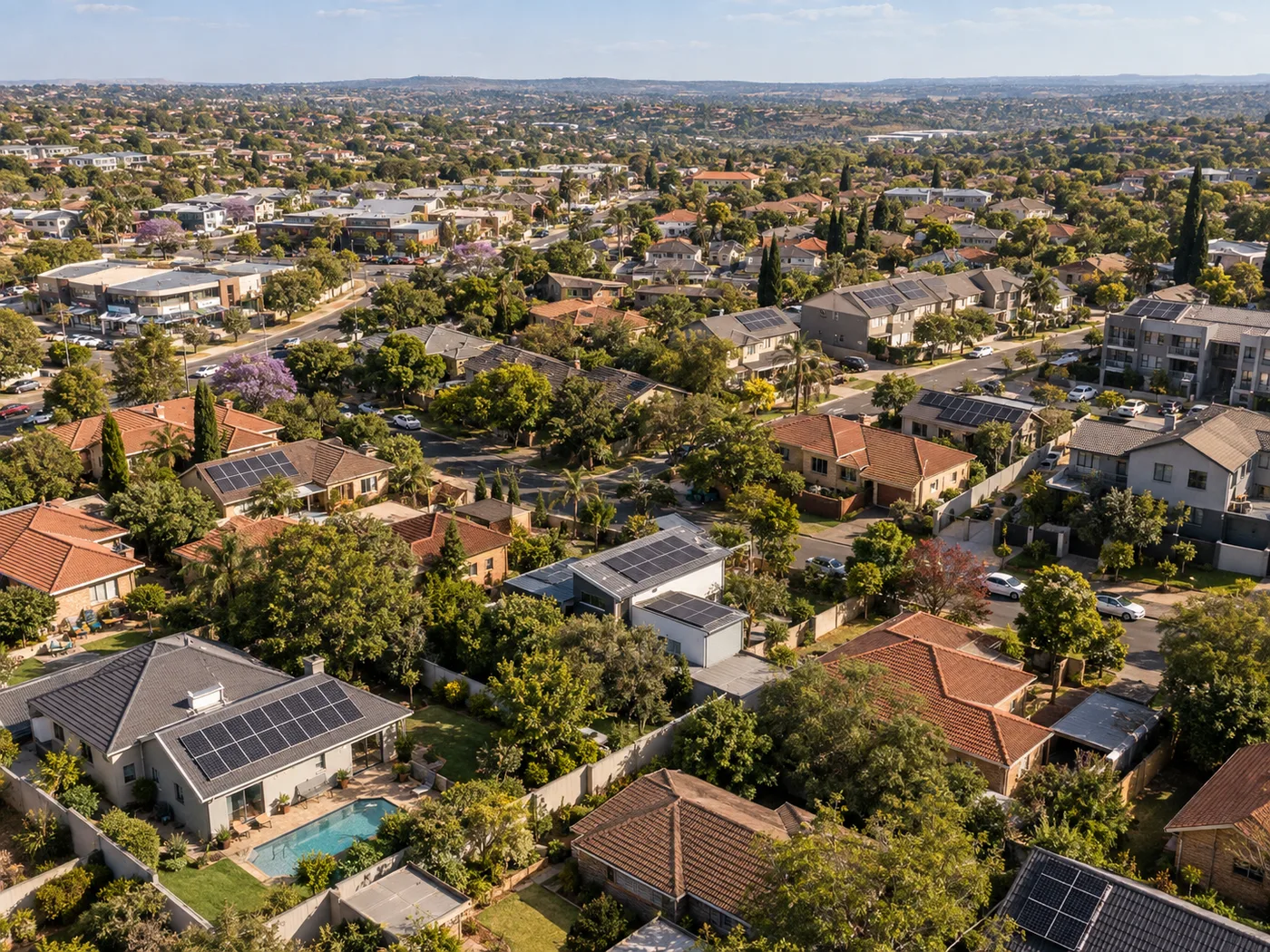 Aerial view of solar installations across a diverse South African suburb
